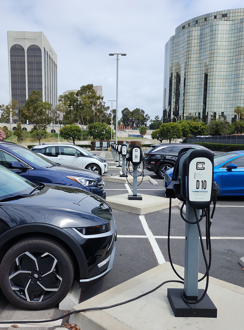 Perspective image of standalone EV chargers being controlled by three Hydra-R™ units in the background.