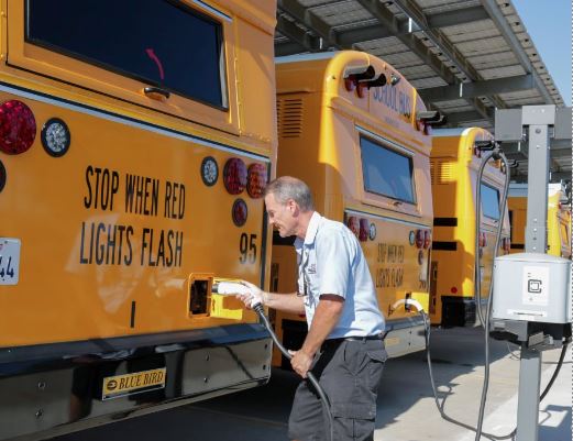 Charging an EV bus in a fleet at Clovis School Disctrict.